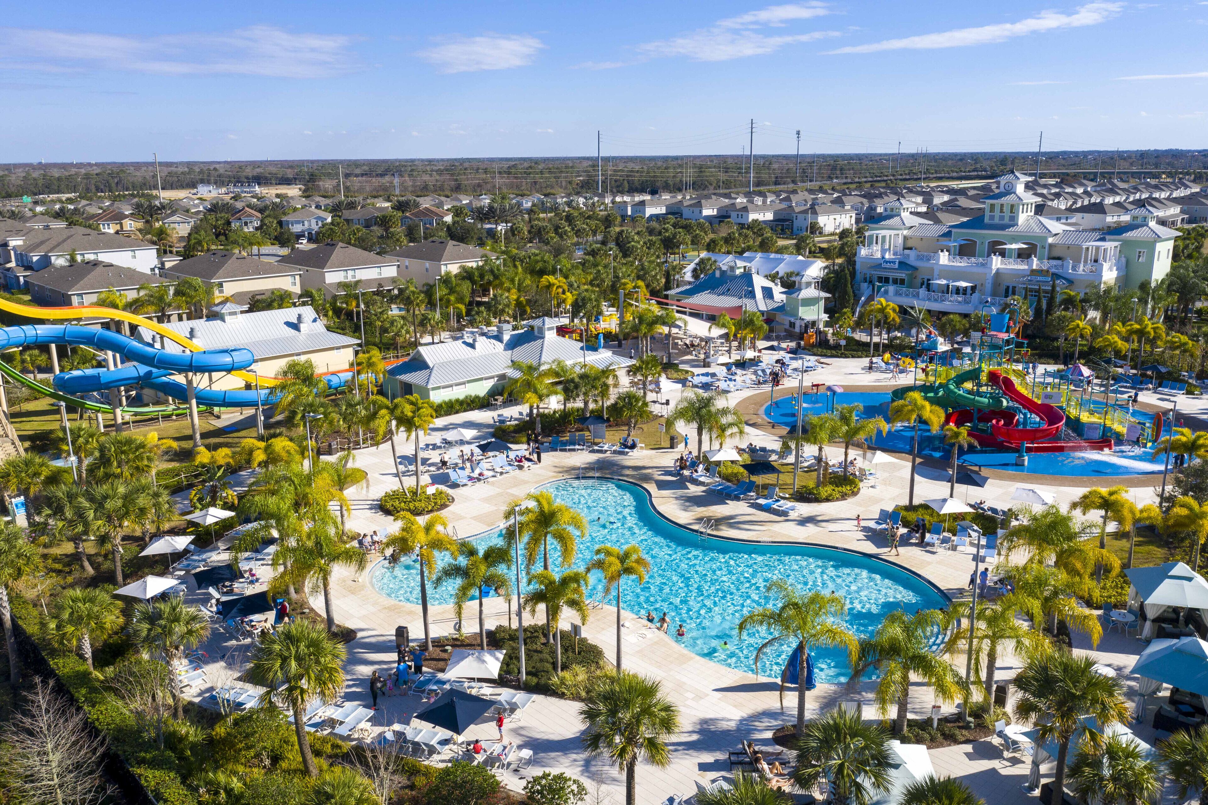 Ein Resort mit großem Pool, Wasserrutschen und Palmen.