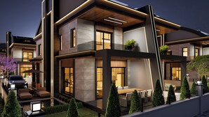 A modern two-story house with a flat roof, large windows, and a well-maintained garden. - TİMEX VİLLA 1 (Finike)