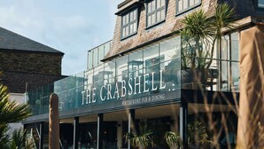 A building with a sign that reads 'The Crabshell' indicating a waterfront pub and dining establishment. - The Crabshell (Kingsbridge)