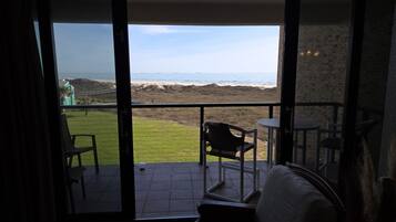 Un balcón con vistas a la playa y al océano.