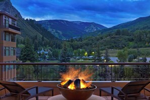 A balcony with a fire pit, overlooking a mountainous landscape with a view of a valley and a building in the background. - Spacious, luxury villa at 5-star Westin Riverfront. Best pool, spa, fitness,etc! (Avon)