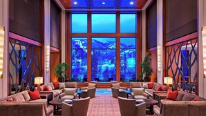 A spacious lobby with a large window offering a view of a mountainous landscape. - Spacious, luxury villa at 5-star Westin Riverfront. Best pool, spa, fitness,etc! (Avon)