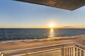A beach view with a railing in the foreground. - Beachfront Condo/ Pool/ Surfing/ Fishing (Virginia Beach)