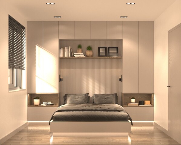 A modern bedroom with a large bed, built-in shelving, and a window with blinds.