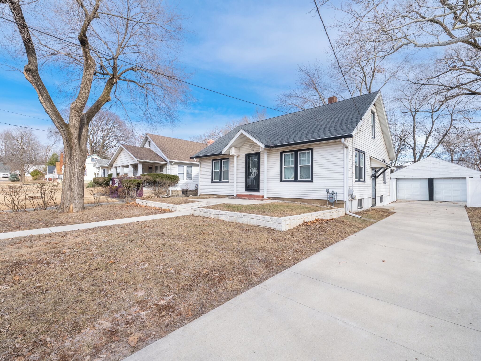 A single-story house with a front porch, a garage, and a well-maintained lawn.