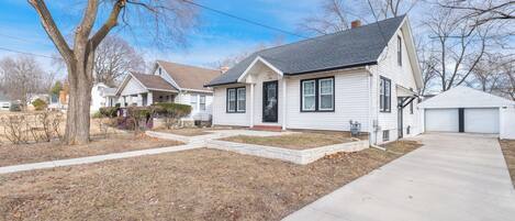 A single-story house with a front porch, a garage, and a well-maintained lawn.