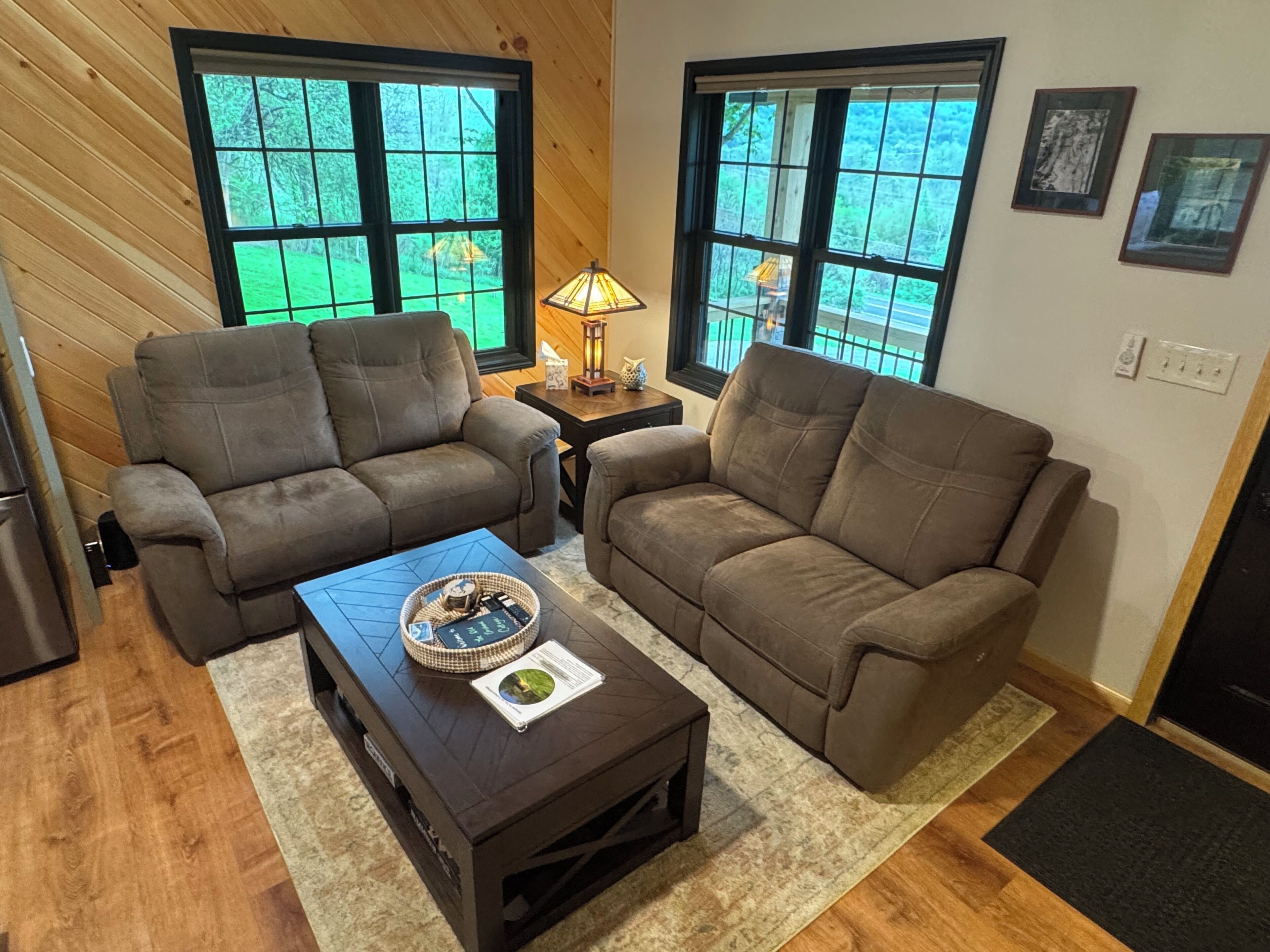 A living room with two sofas, a coffee table, and a lamp.