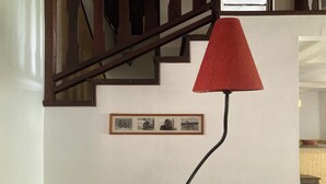 A staircase with wooden railings and a red lamp post.