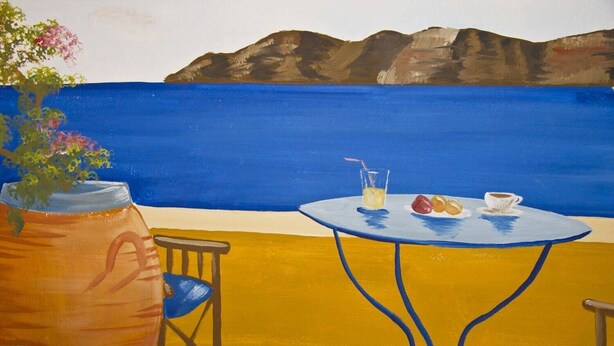 A table with a vase of flowers, a glass of drink, and a plate of fruit. - Sweet Pop (Santorini)