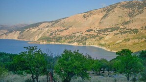 A coastal landscape with a clear view of the sea and a hilly terrain in the background. - Effie's Escape Spacious House in Zola (Argostoli)