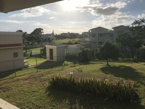 A residential area with houses, a fenced yard, and a small building. - 2-bedroom ocean view villa in lovely Boquerón with AC and charm (cabo rojo)