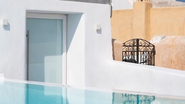 A white building with a blue dome and a pool. - White Concept Caves - Adults Only (Santorini)