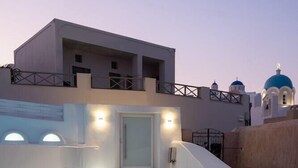 A modern building with a staircase leading to a door, surrounded by white walls and a balcony. - White Concept Caves - Adults Only (Santorini)