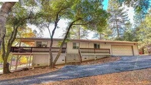 A single-story house with a front porch, a garage, and a covered driveway. - Recently Renovated 3 Bedroom house in Groveland with Central Heating and Air (Groveland)