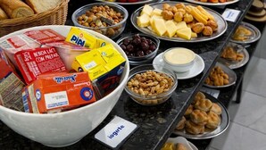 A buffet with various food items including fruits, cheeses, and bread. - Pousada Doce Mar: Comfort and tranquility just steps from the beach. (Maragogi)