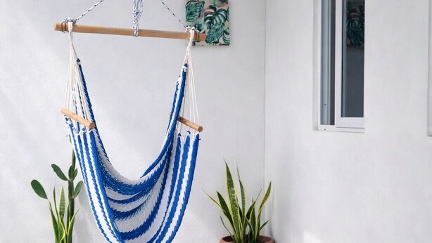 A hammock suspended by a wooden frame, a potted plant, and a poolside area with a concrete floor. - Modern Apartment w Private Pool (Chiquimulilla)