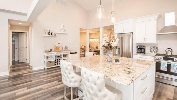 A spacious kitchen with a large island, white cabinetry, and stainless steel appliances. - Spacious, 5 Bedroom/3.5 Bath In The Hear of Ocean City (Ocean City)