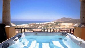 A hot tub with a view of the ocean and a mountainous landscape. - MONTECRISTO Charming 3-bedroom villa with AC in marvelous Cabo San Lucas (Cabo San Lucas)