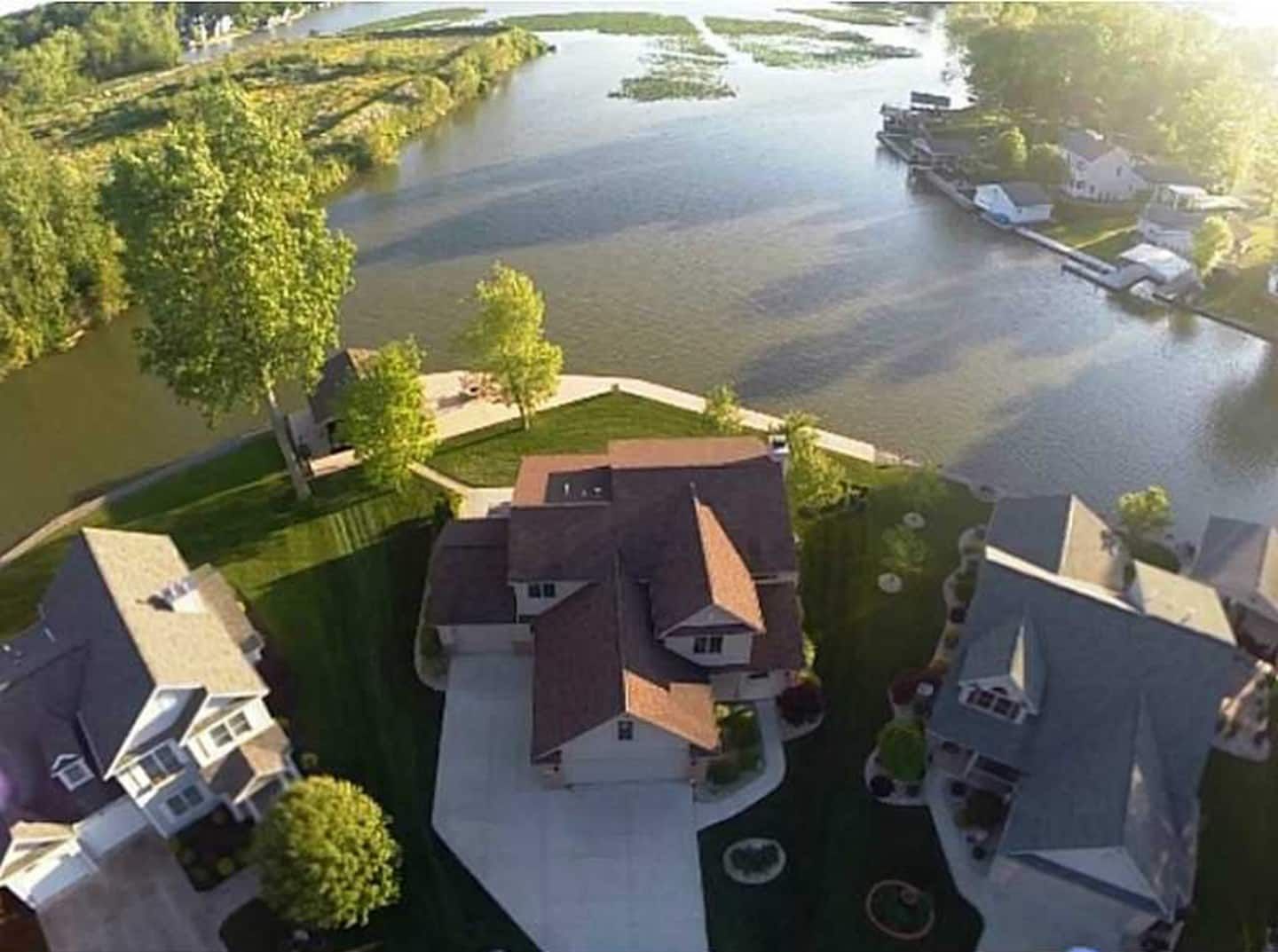 A residential area with houses, a river, and a dock.