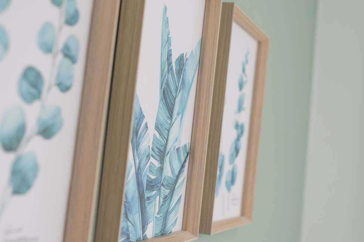 A wall with framed botanical prints.
