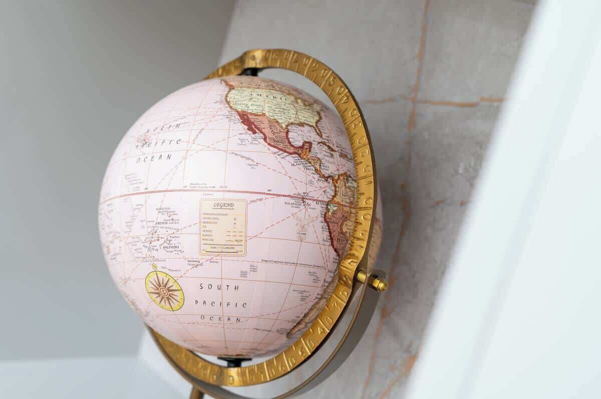 A globe with a compass rose and a legend, mounted on a stand.