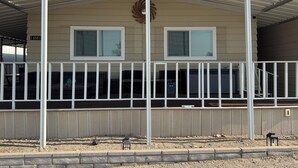 A two-story building with a covered balcony, a decorative wreath, and a number '14861' on the wall. - Hit the Trail or Lake: Spacious 4BR/2BA Retreat with Pool Table & Large Bar Area (Needles)