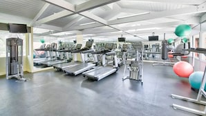 A gym with treadmills, weight machines, and exercise balls. - Disneyland Days, Surf City Waves, Newport Nights (Costa Mesa)