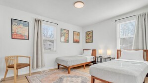 A bedroom with two single beds, a wooden chair, a rug, and three framed posters on the wall. - 5Min to Downtown Franklin/Pet Friendly/Fenced Yard (Franklin)