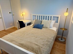 Tabla de planchar con plancha, internet y ropa de cama