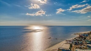 A coastal town with a beach, buildings, and a pier. - Beach/Pool Access Cottage - Walk to Times Square, Fort Myers Beach (Fort Myers Beach)