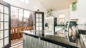 A modern kitchen with a large island, a refrigerator, and a sink. - Whitewater Lodge-4units*nearDT (Boise)