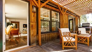 A wooden deck with outdoor seating, large windows, and a pergola. - Whitewater Lodge-4units*nearDT (Boise)