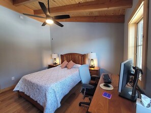 A bedroom with a bed, desk, computer, chair, and a ceiling fan. - 4 Bed Luxury White Mtn Retreat w/ Stunning Views! (Campton, NH)