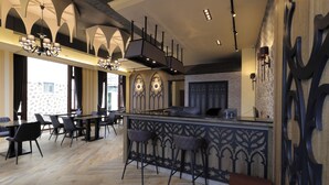 A modern restaurant with a bar area, wooden flooring, and gothic-style wall decorations. - Nottingham Seaview B&B (Hualien City)