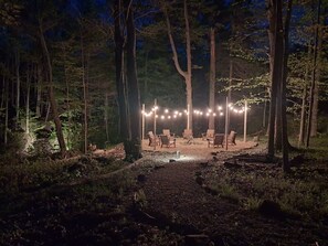 A forested area with string lights and outdoor seating. - Grand River Estate IndoorPool/Swim Pond/25 Acres (Thompson)