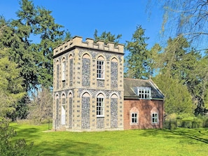 A historic building with a tower, arched windows, and a brick facade. - 3 bedroom accommodation in High Ash (High Ash)
