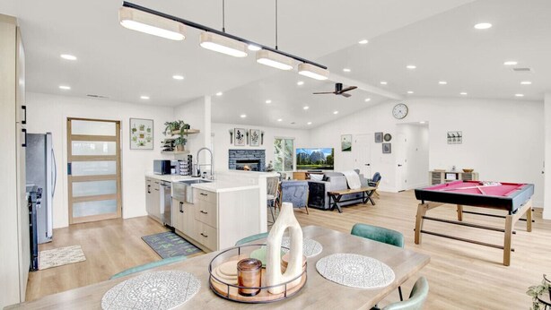 A spacious living area with a dining table, a sofa, and a pool table. - Yosemite/Bass Lake Villa+HotTub EVcharger (Oakhurst)