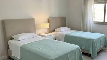 Luxury Condo, Partial Sea View | In-room safe, desk, laptop workspace, blackout drapes