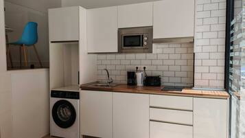 Mini-fridge, microwave, stovetop, cookware/dishes/utensils