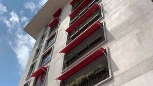 A multi-story building with balconies, some with plants. - Spacious 2-BR apartment in the best location! (San Rafael de Escazú)
