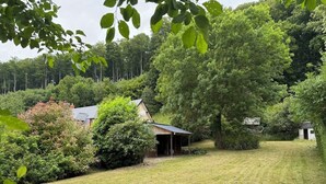 A rural property with a house, a small shed, and dense surrounding vegetation. - L écrin de l aube  (Grainville-la-Teinturière)