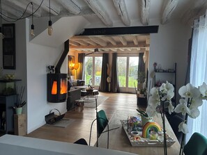 Una sala de estar acogedora con chimenea, un sofá y una zona de comedor decorada con un arcoíris.
