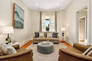 A living room with a sofa set, a coffee table, and two lamps.