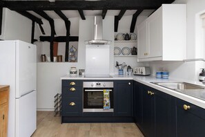 Fridge, microwave, oven, stovetop - The Collector’s House is a beautifully restored 3-bedroom home located on Arundel’s picturesque High Street, offering a unique blend of historic charm and modern comfort. (Arundel)