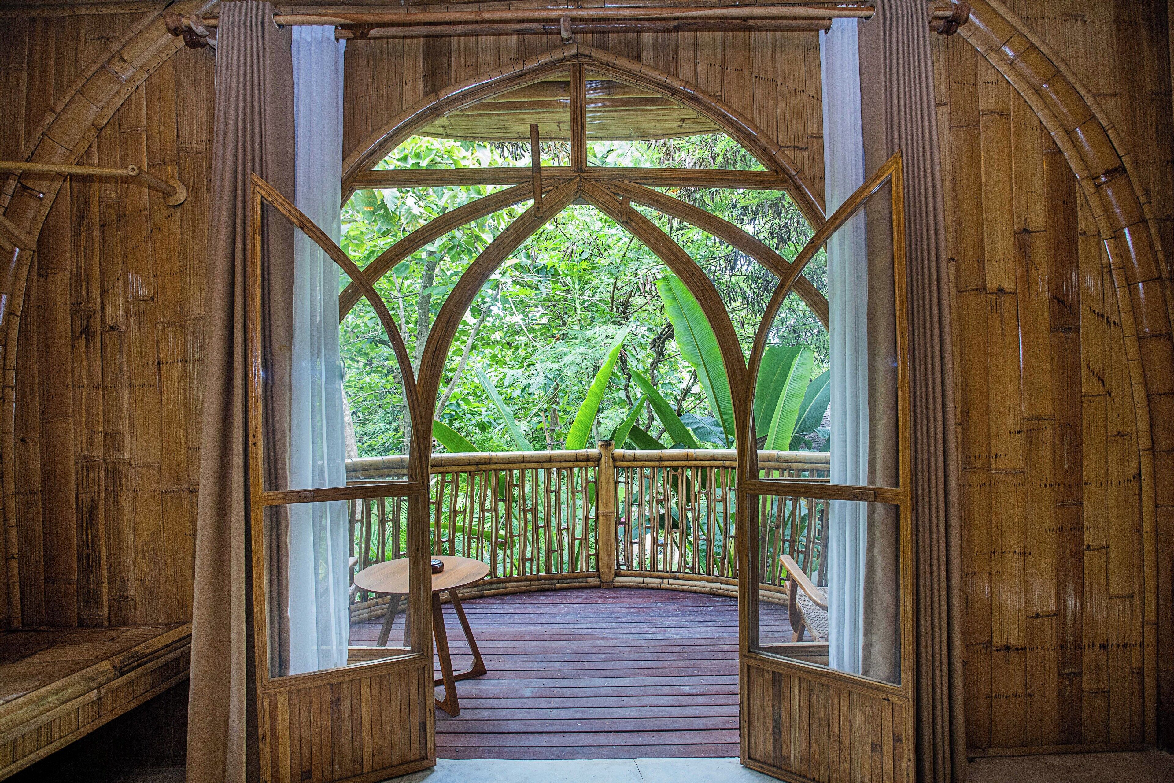A wooden deck with a view of lush greenery.