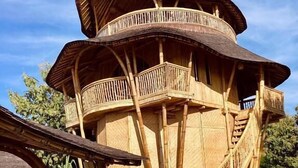 A multi-level wooden structure with balconies and stairs.