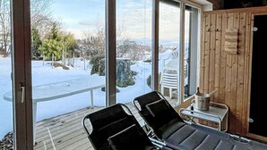 A room with large windows, a wooden deck, and a sauna area. - Schwarzwaldhof mit Pool & Sauna by Interhome (Görwihl)