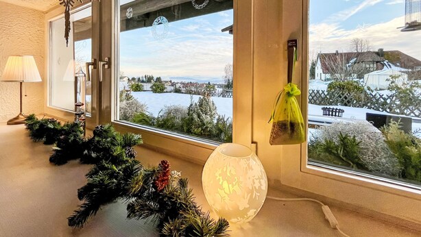 A room with large windows, a decorative snowflake, a lamp, and a vase. - Schwarzwaldhof mit Pool & Sauna by Interhome (Görwihl)
