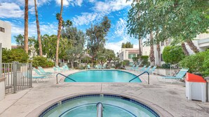 A swimming pool with lounge chairs and palm trees. - 2 Mi to Dtwn Palm Springs! Modern Condo w/ Pool (Palm Springs)