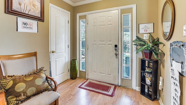 A clean, well-lit entryway with a wooden bench, a red doormat, and a no smoking sign. - 8 Mi to Augusta National: Group Getaway w/ Deck (Augusta)
